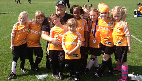 Coach Shane Snively with his soccer team, the Dynamos
